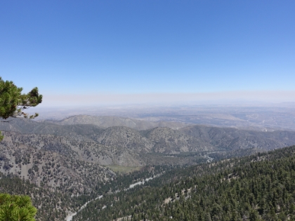 A look down to the valley on the other side. I'm not sure what those large meadow areas are, but they look like they're worth exploring. You can see the air below is still tainted by the wildfires in the area.