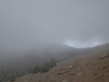 Visibility starts to drop on the trail and there's rain and hail for a while.