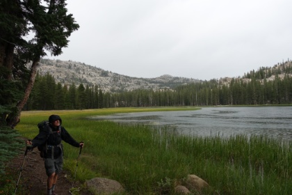 Dad walking along Wilmer Lake in what is now a pretty heavy rain. It's getting late, the rain is getting heavy, and we're pushing on trying to find a good tent site for the night. There haven't been any dry, open areas for a while now.