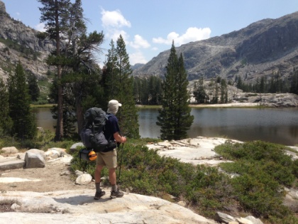 Dad's picture of me taking in the view at one of the gorgeous lakes along the trail.