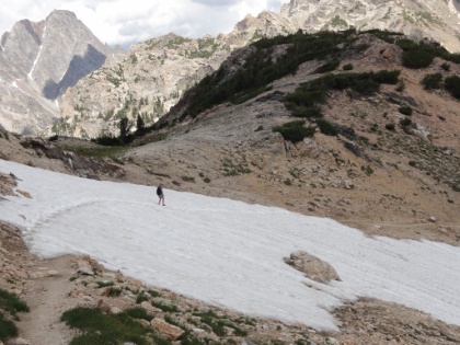 A day hiker on a decent sized snow traverse. No problem with trekking poles, but my heavy pack doesn't make it any easier. It would be a long slide down if you slipped.