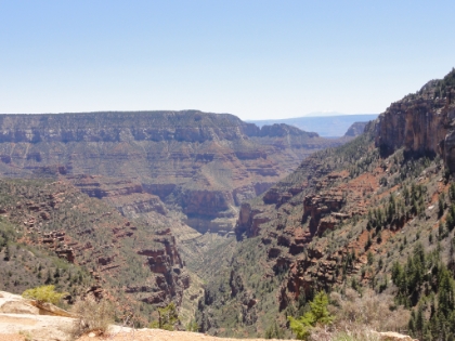 Now back up in the Coconino Sandstone layer less than 1000' below the North Rim. From here you can see where Roaring Springs Canyon joins with Bright Angel Canyon. You can also see the South Rim in the distance. And you can just barely see a snow-capped peak in the far distance, which is one of the San Francisco peaks near Flagstaff over 70 miles away. I'm really starting to crash, but the rim is getting close...