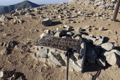 Made it to the top. It's after 6:00pm already, which is pretty late to be summitting. I open my hydration bladder to sip out the last couple drops. I'm now entirely out of water and have about 1/3 of a protein shake to last me the last 6 miles. I'll have to ration carefully.