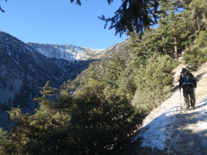 Dad crossing one last patch of snow with the last view of the bowl in the distance.