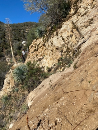 After multiple attempts to cross, I decided to go up and around instead. After a crazy scramble through the razor sharp brush, I finally make it to the other side. My legs looked they had been massaged by a cheese grater, but I was ready to continue on. Dad was nice enough to wait for me here.