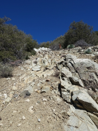 Loose rock and scree. The way down is like scree surfing. Wipeout potential here is really high.