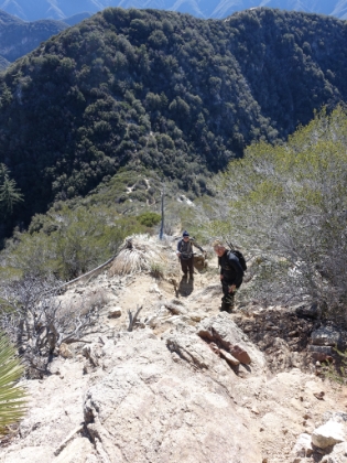 Looking down at the saddle. I finally have some humans in the picture to help give some perspective to just how steep the trail gets here.