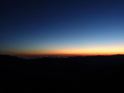 The last 1 1/2 hours or so of our trek was in the dark. Here's the last of the sun and also the flickering lights from the distant city below.