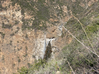 I follow the remnants of a use trail that's incredibly steep and loose. But you can gradually see more and more of the falls. It's tantalizing, making you want to keep going just a little further to see more.