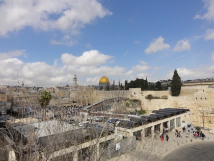 Looking down onto the Western Wall plaza with a view of the Western Wall, Dome of the Rock, and the Mughrabi bridge.