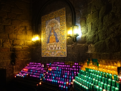Cami de l'Ave Maria. Patrons light candles in homage to the Virgin Mary. The flickering colors in the dimly lit alley are beautiful.