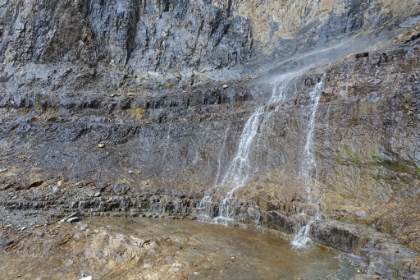 The trail walks right across the base of the falls.