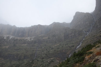 Multiple cascades running down the cliff face.