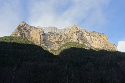 The cliff walls are evidently a combination of limestone and sandstone that erode at different rates.