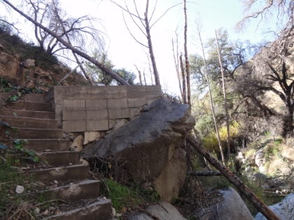 It's clear this area was devasted by floods and fire. Here is what looks like the remains of a footbridge across the creek.