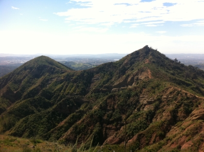 Deep, green canyons. At this point, I'm about 8 miles into the run, and I've only gained around 1500'. That's respectable, but I start doing the math and realize that I still have almost 3000' to the top and it can't be more than 4 miles away. There must be some steep trail ahead!