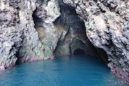 Our 62' catamaran slowly inches its way into the cave.