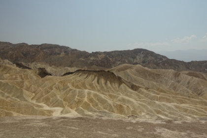 It looks like someone painted some of the peaks. This was once the bottom of a giant lake bed, and the sharp color constrast is the result of lava that oozed out through the lake floor. Now the terrain is formed from errosion and shifting fault lines.