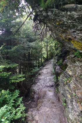 The trail is narrow, slick rock. Evidently enough people have ate it here that the park service needed to add cable hand holds in several places.