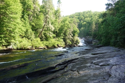 Downstream of the falls, you can wade out into the river and play on the rock slides.