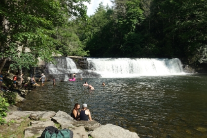 It's a short waterfall, but still carries an impressive amount of water. It's an extremely popular swimming hole in the hot weather, and it's packed with people.