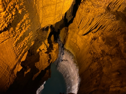 A small underground lake far below.