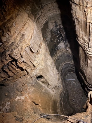The "bottomless pit" over 105' deep. The original cave explorers, traveling only by lantern light, would have thought it was truly bottomless. They laid a wooden plank across the pit in order to get across. Now there's a nice tourist bridge instead.