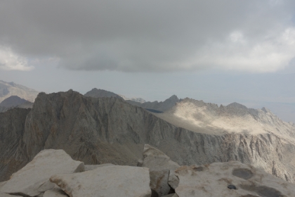 Another summit view with a huge bowl lake in the distance.