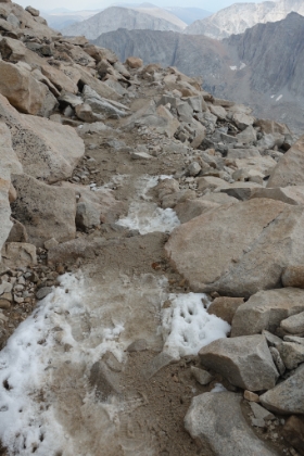 A look at some of the rocky trail with patches of snow that I flew-up earlier.
