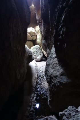 It's actually much darker than it appears in the pictures. My new camera works so well in low light, it's magnifying the small amount of light streaming in from the gaps in the boulders above. A headlamp is definitely required through most of the cave.