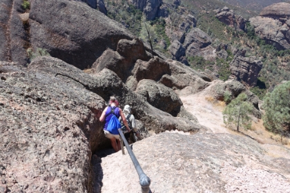 A view of a couple hikers heading down a steep section of the trail.