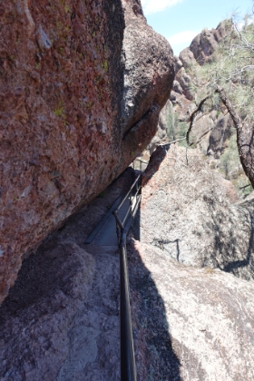 Bridge over a little gorge and some railing saving you from a drop off the cliff.