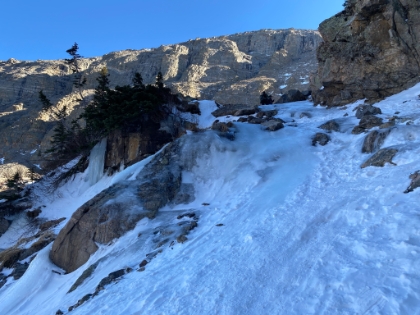 Approaching the crux of the hike. I had read about this section and it had me a little nervous. Seeing it in person now has me REALLY nervous. The trail goes right over that smooth section of ice. It's really steep with a dropoff to the left that  might be survivable, but would definitely mean a broken body. The ice is crystal clear, at least six inches thick, smooth as glass, with a slick wet surface. It's the most slippery surface I have ever been on, and it's not even close. Absolutely zero traction. I was really wishing I had my Microspikes instead of the Yaxtrax, but I had to travel light. The coils are great for relatively flat terrain, but they aren't made for this. I tentatively started heading up.