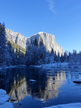 El Capitan and its reflection on the Merced.
