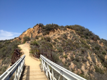 The trail bridge leading up to a prominent peak near Will Rogers State Historic Park.