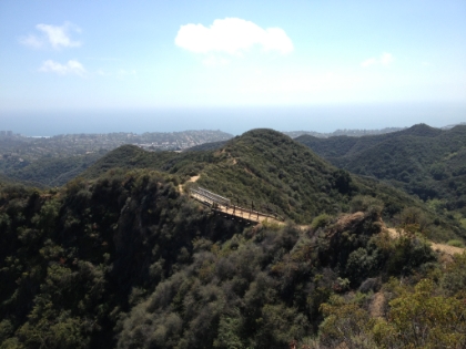 Looking down at the trail bridge and out towards the ocean.