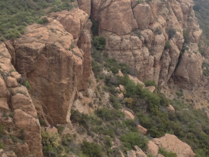 Zoomed in on a group of rock climbers at the base of the cliffs.
