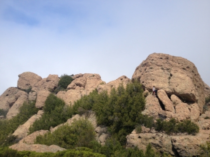 A couple guys look stuck scrambling around the peak.