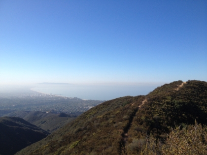 The trail along the ridge with the coastline in the distance.
