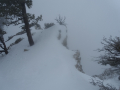Don't want to slip over there! Unfortunatley, this is one of the last pictures I was able to take. My fingers were starting to really hurt, and I couldn't look up into the wind for more than a couple seconds at a time, and my camera was fogging up again. After the ridge section, the trail started geting pretty steep and really icy, and the set of tracks I was following came to an end. So that would have to be my turnaround point. 2:45pm. I only had a few hours to be off the mountain and then to be someplace an hour away! Fingers crossed I don't lose the trail on the way down.