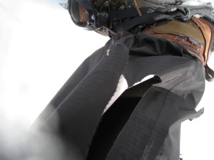 This is why you use snow gaiters while wearing crampons! If you happen to slip or stumble (which is frequent in the snow when you're fatigued) and your crampons even slightly graze your other leg, your pants, socks, shoes, and skin are in trouble. Here you see the gaping hole in my now ruined $100 pair of wind shell pants. By the end of the trip, the tear would be up to the knee. I also put a hole in my sock and in my boot. I will never forget my gaiters again!