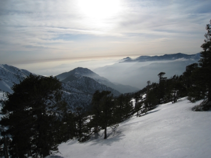 Sunset is nearing and a misty fog starts to settle into the valleys between the peaks. The scenery is absolutely stunning. I wish I wasn't in such a hurry to get down so I could enjoy it more.