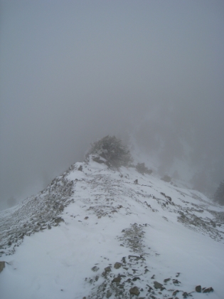 As I head back down the ridgeline, visibility gets even lower, the temperature is back down to 18 degrees, and the wind picks up. But, my toe is starting to warm-up and I'm actually feeling pretty good.