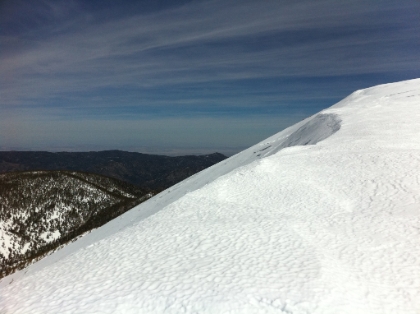 Just about up to the ridge. This is looking back where I just came from. You can see some of my traversing tracks across the slop in the distance again giving you a little idea of what the slope is like.