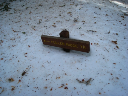 My pace has now slowed to a crawl. I spend a lot of time correcting my course, and my hopes of summitting are starting to fade. But, according to the GPS, there should be a trail split right... here! The GPS leads me to within feet of this signpost. Now this was undoubtedly a short sign to begin with, but the snow is getting pretty deep. Later in the winter, this trail split will be invisible. I'm now at 8940'.