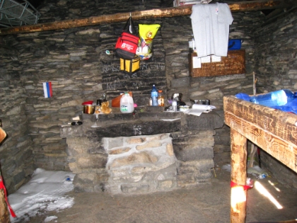 The shelter was built in 1933 by the Civilian Conservation Corps. Backpackers leave it stocked with gear for fellow travelers, and there are two bunk beds. Since there's actually snow inside, I doubt it's very weatherproof.
