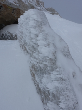 More snow and icicles growing horizontally from the wind.