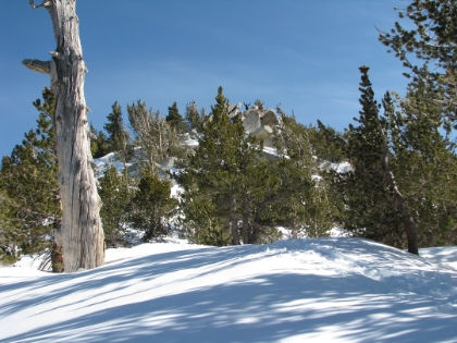 It was a bit tricky to figure out how to actually get on top of those rocks, but I made it. The wind was howling up there, where it was almost dead calm at the saddle. I actually had to brace myself to strike this pose. Definitely a picture I would never have when on my own.